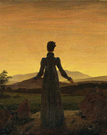 Femme devant le coucher de soleil